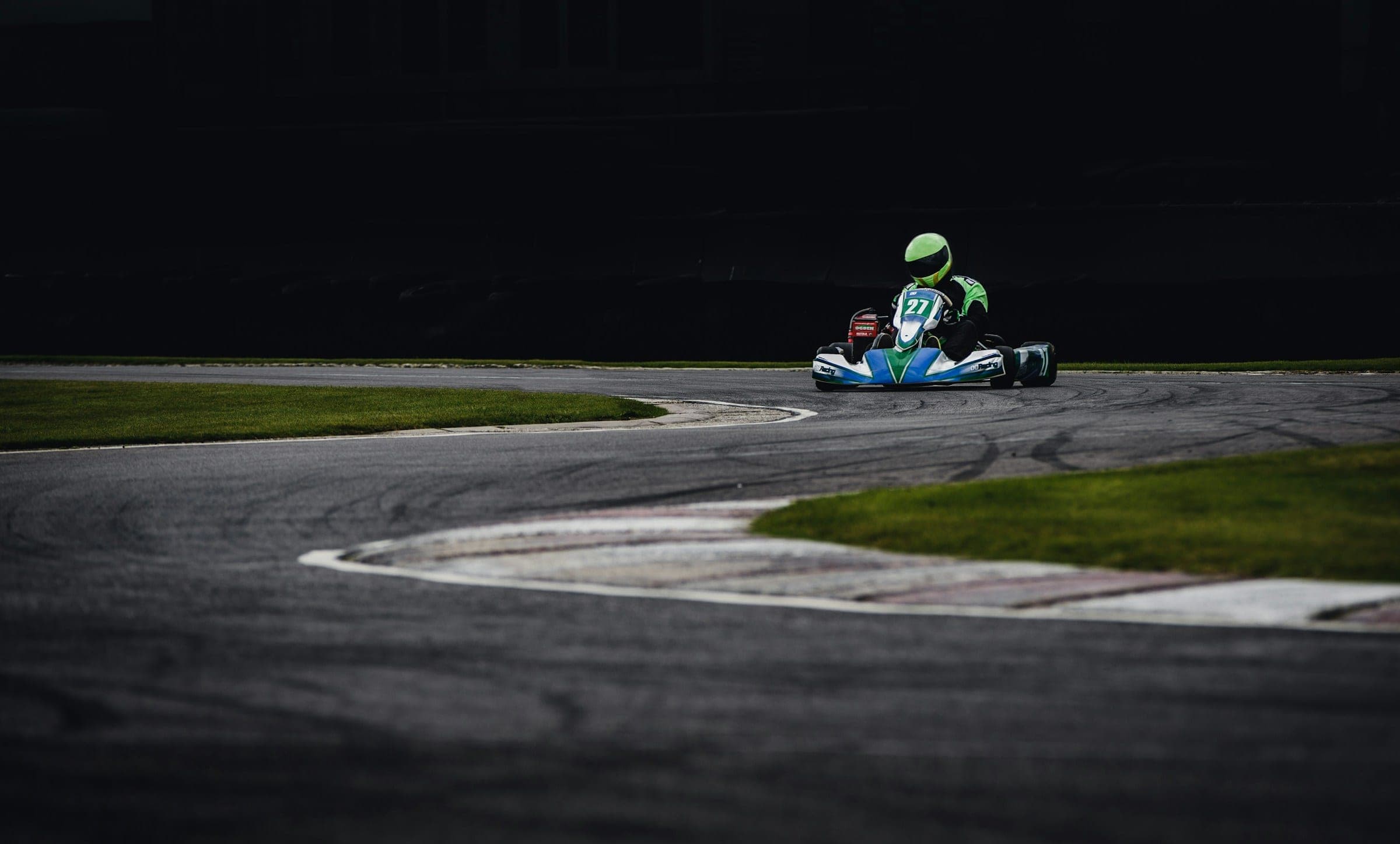 A kart racer taking a corner on a circuit, reference photography